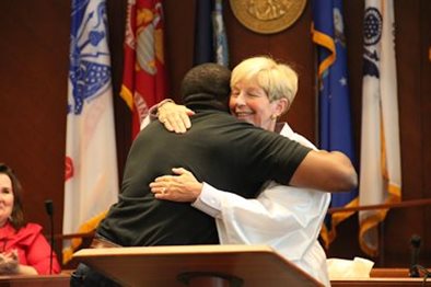 Judge Joanne Smith hugging a Drug Court graduate